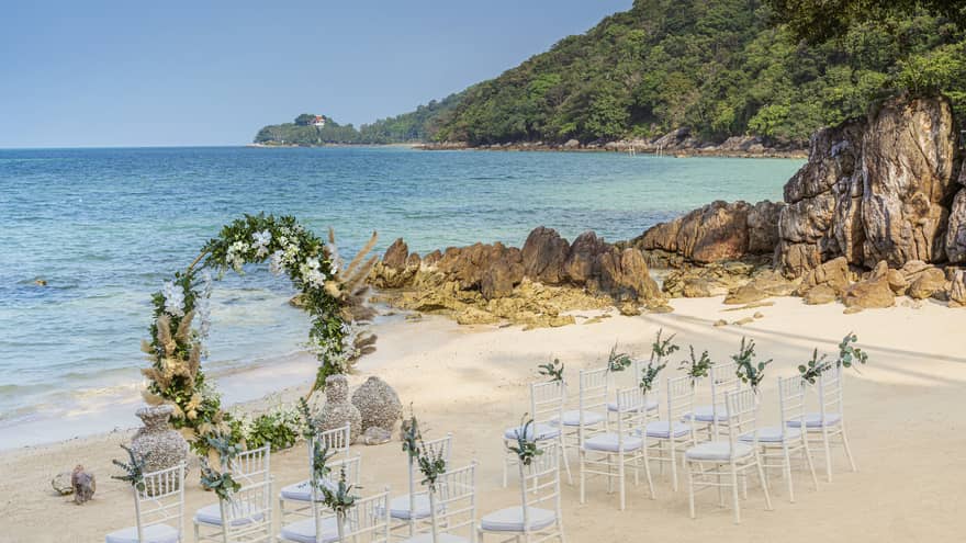 Wedding setup on beach with round flower arch