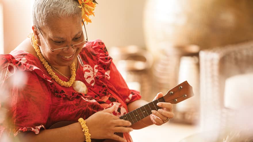 Close-up of Hawaiian elder playing ukulele