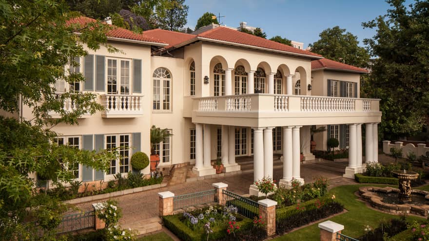 Jacaranda Conference facility building exterior with white columns, gardens