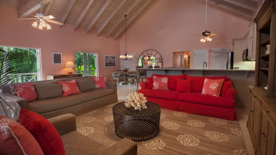 Residence living room, red, brown sofas under soaring wood beam ceilings