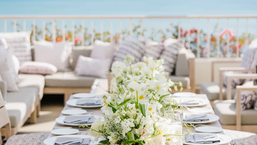Set dining table on private terrace overlooking ocean