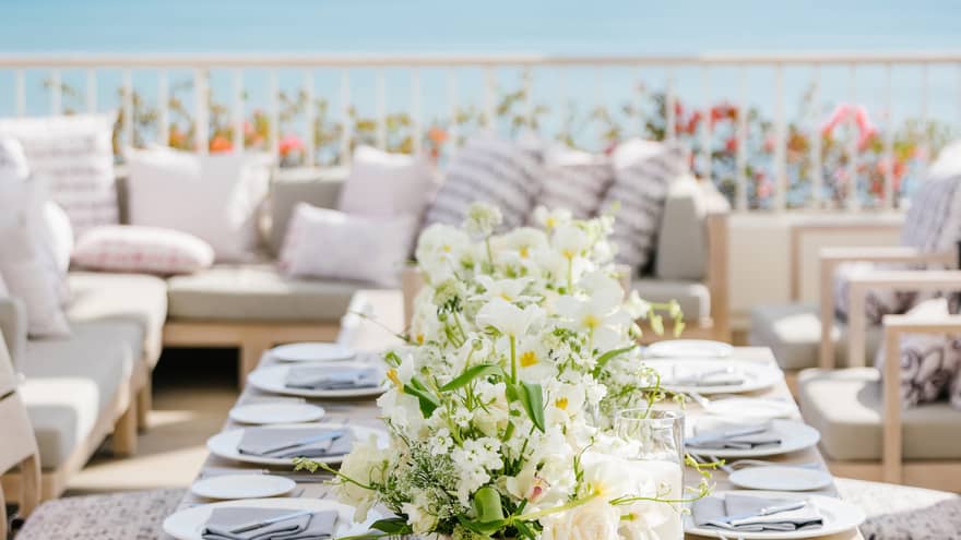 Set dining table on private terrace overlooking ocean