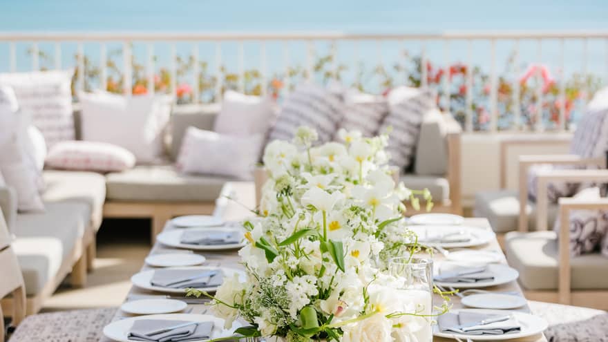 Set dining table on private terrace overlooking ocean