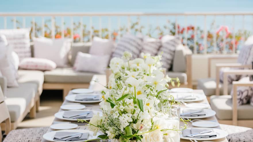 Set dining table on private terrace overlooking ocean