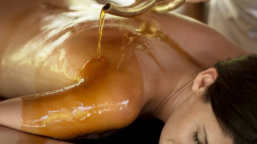Hot oil poured on woman's bare back, shoulders 
