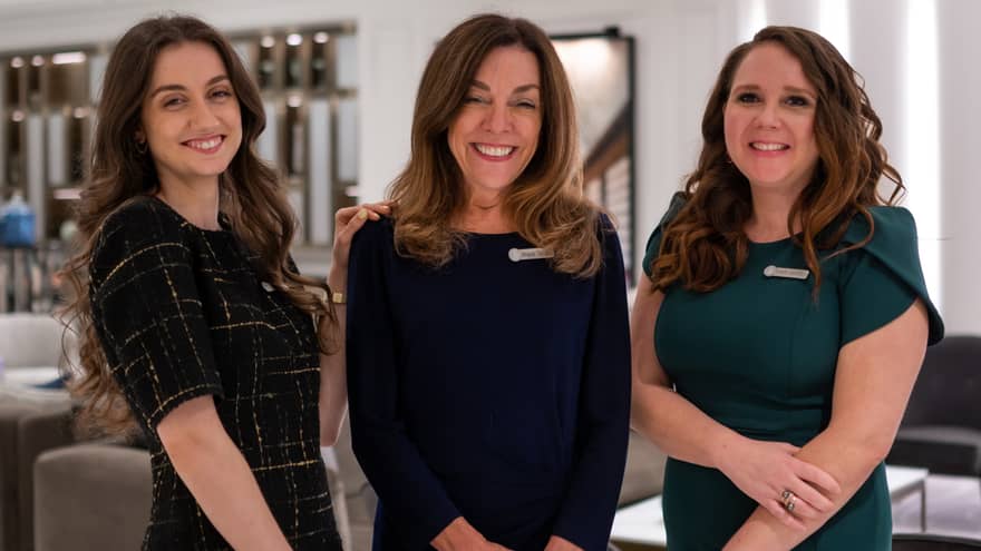 Three smiling women from the wedding planning team