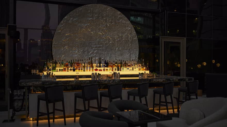 Illuminated bar in dark outdoor lounge