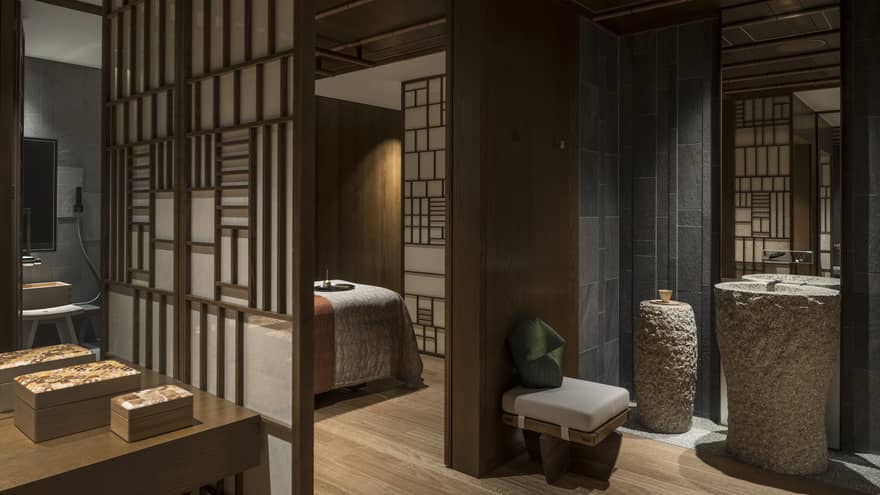 Spa treatment rooms behind screens, large stone vases