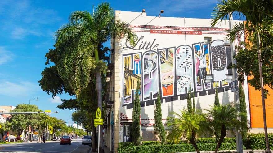 Street with Little Havana painted billboard sign, palm trees