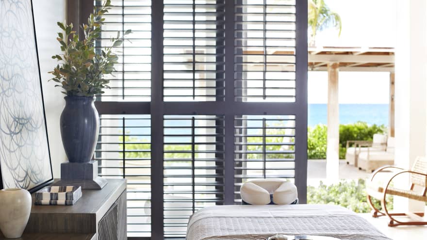 A spa room with a large window open to the outside and natural lighting.