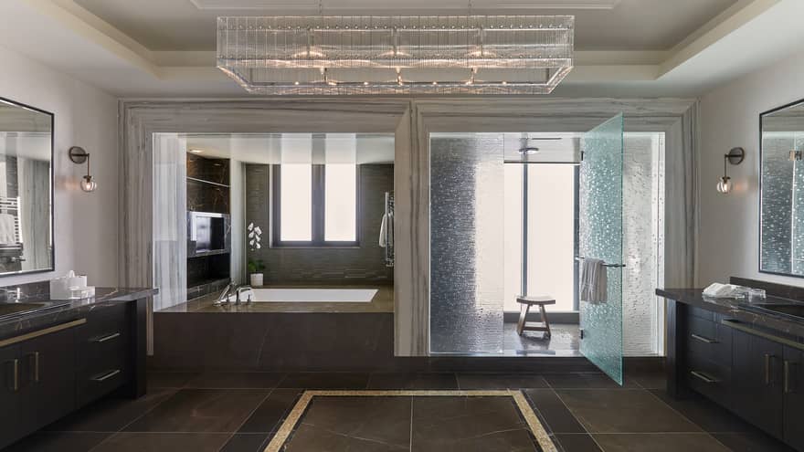 Large bathroom with walk-in shower, deep soaking tub, vanities on each side of the room