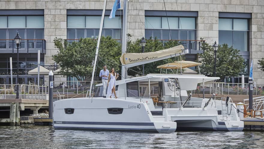 A couple walking onto a white yacht docked in Baltimore’s harbour
