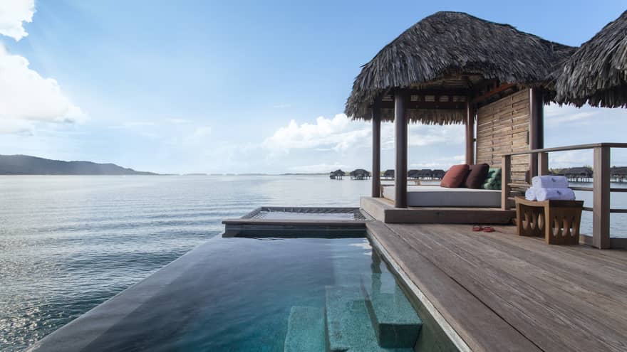 Private deck of Bungalow, with infinity pool and thatched-roof sun bed