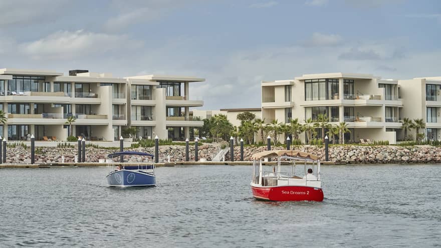Two water taxis moving across water.