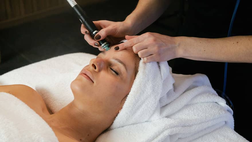 Woman on spa treatment table gets a Hydrafacial