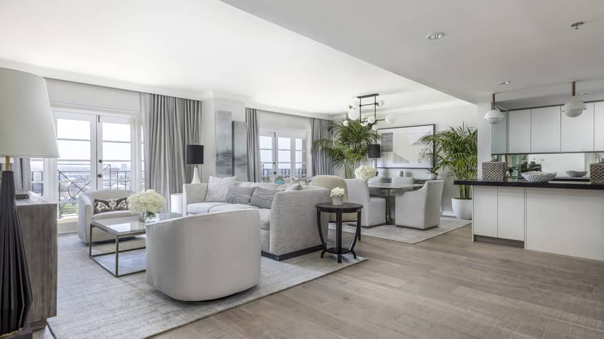 Open living room, dining room and kitchen with wooden floors, modern grey furniture