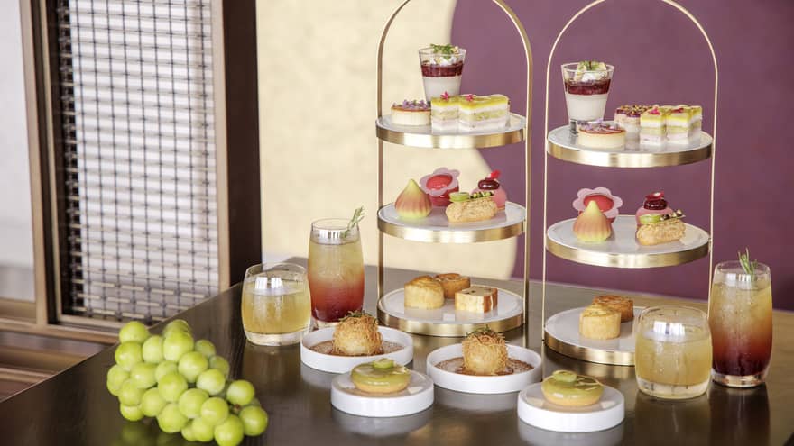 Afternoon tea spread on a table, featuring muscat grapes