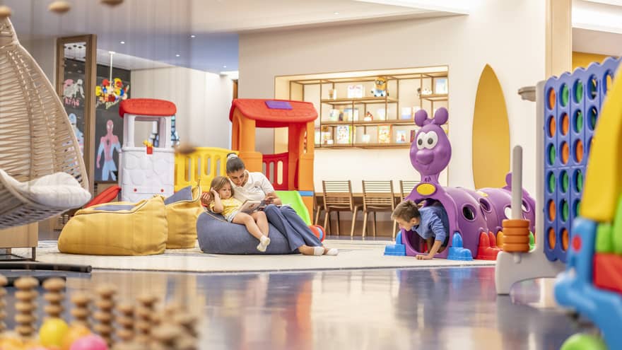 Kids playroom with colourful toys and bean-bag chairs