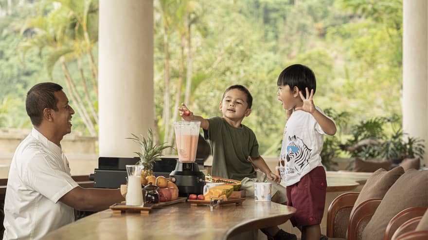 Two young boys make Jati Bar milkshakes with bartender