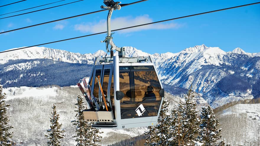 Ski lift heads uphill on snowy Vail, Colorado mountain