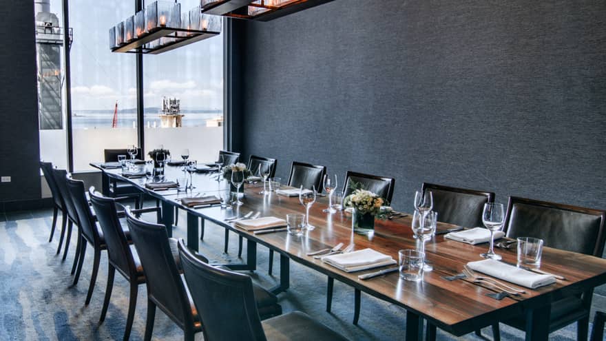 Rectangular table with black chairs and a floor-to-ceiling window.