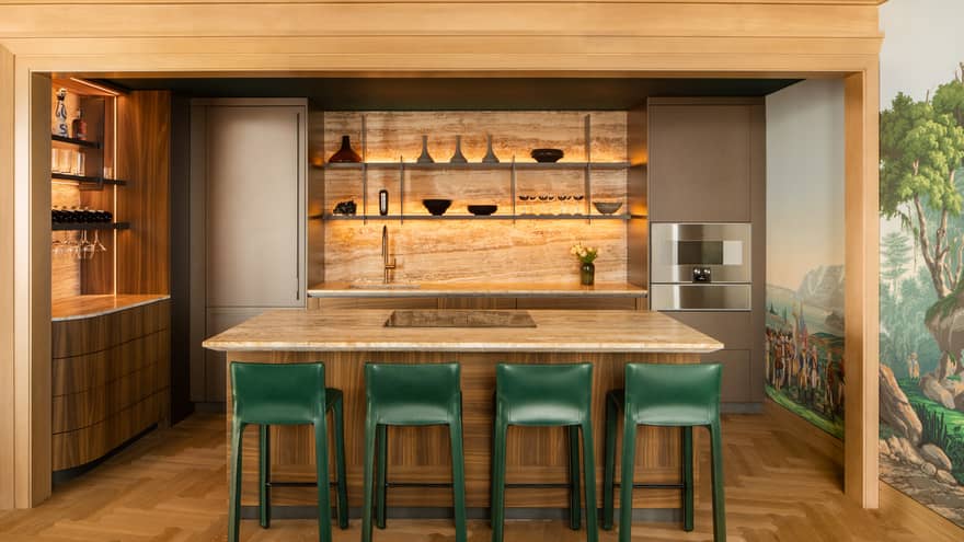 Residential kitchen with island and four green high-top chairs