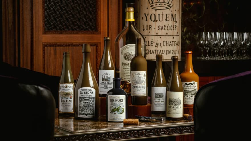 Collection of 9 labeled bottles set on a bar counter