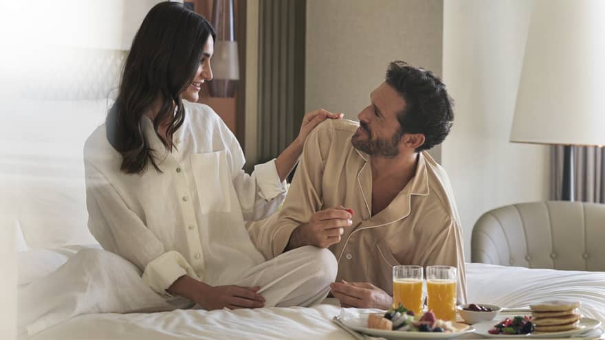 Pajama-clad couple enjoys in-room dining in their guest room