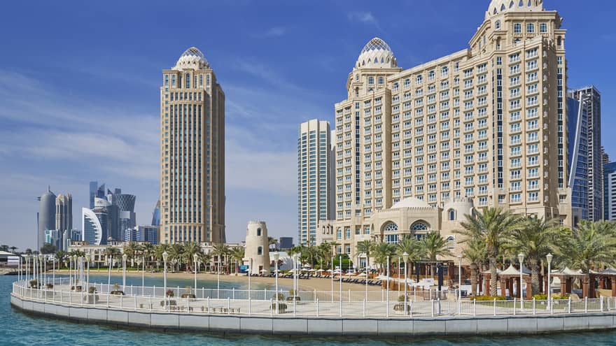Four Seasons Doha hotel high rise building exterior, beach and palm trees