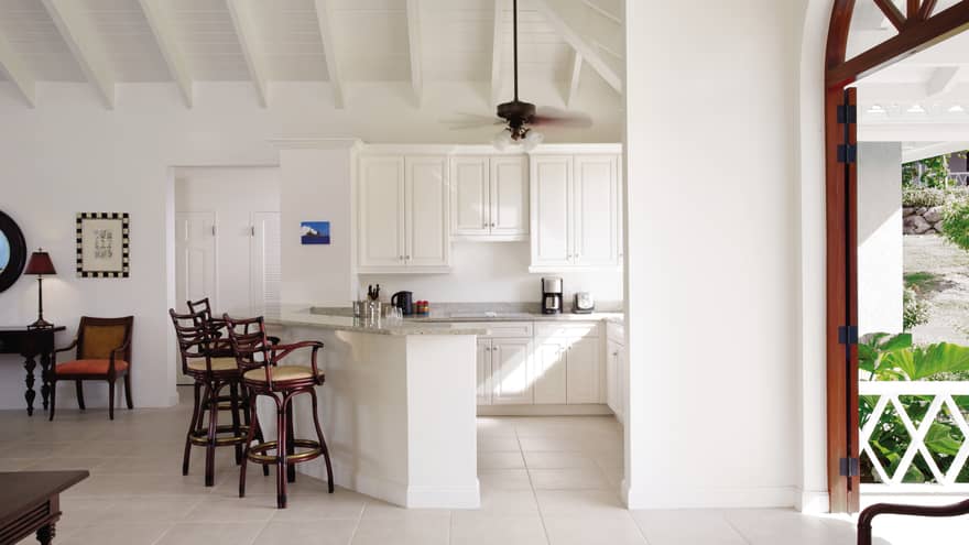 Sunset Hill Residence Villa white kitchen, wood stools at counter