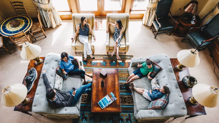 Aerial view of guests talking and relaxing in the living room of a residence 