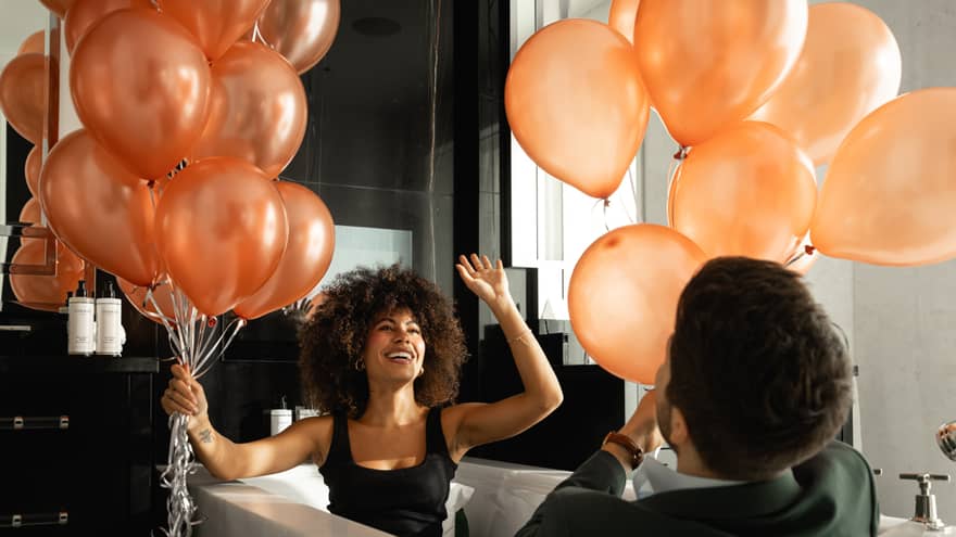 Man and woman playing with balloons