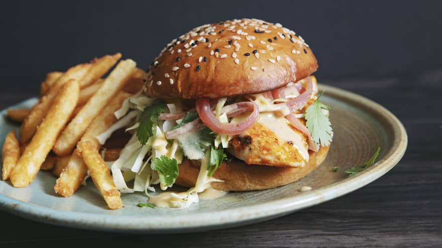 A burger and fries on a plate.