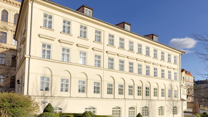 Exterior view of the three-level Neoclassical House building on sunny day