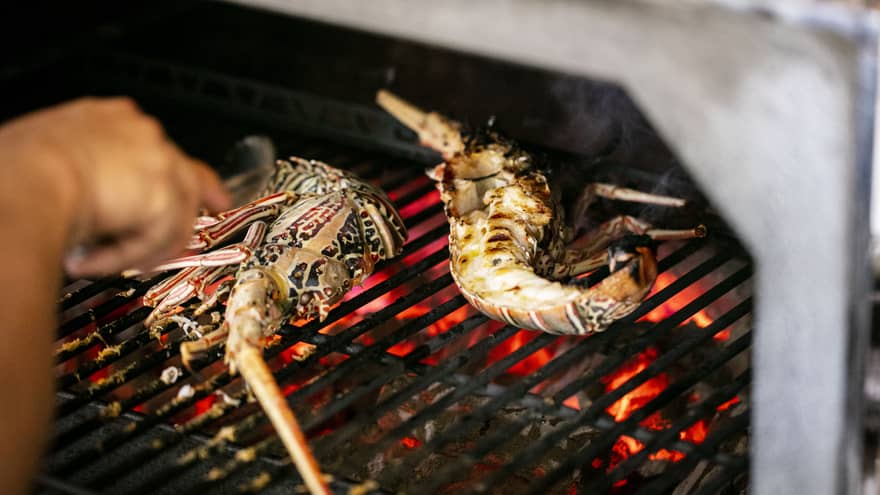 Seafood being cooked on a grill.