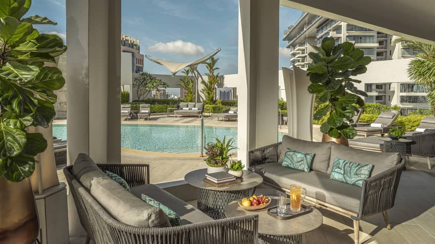 View of 20th-floor from outdoor lounge with grey poolside furniture
