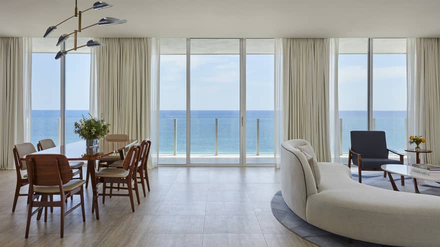 Dining room table and curved sofa, ocean view