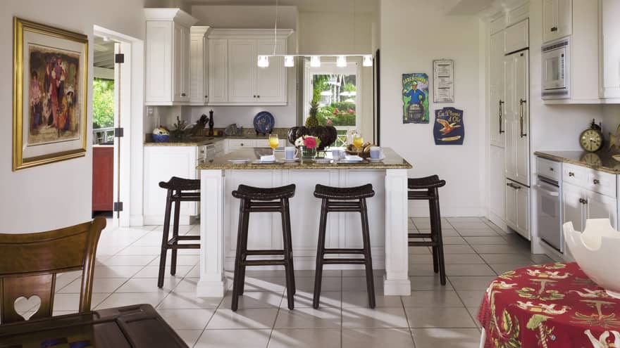 Palm Grove Residence white kitchen, island counter lined black stools