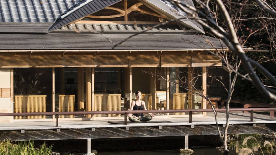 Woman meditates outdoors at FUJU Lounge