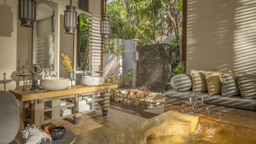 Large bathroom with natural materials, sofa and outdoor shower