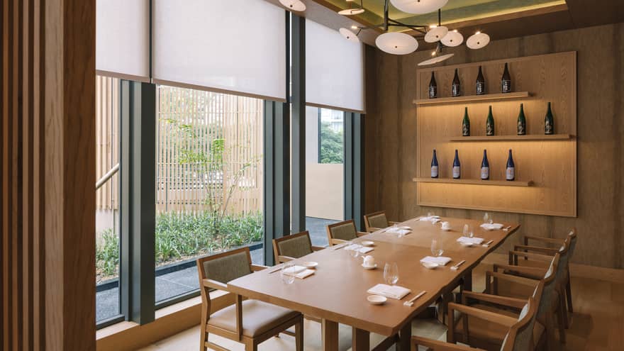 Sake Room at Nobu Singapore with wine bottle wall display, floor-to-ceiling windows, wood panelling