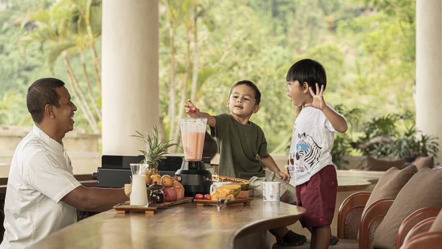 Two young boys make Jati Bar milkshakes with bartender