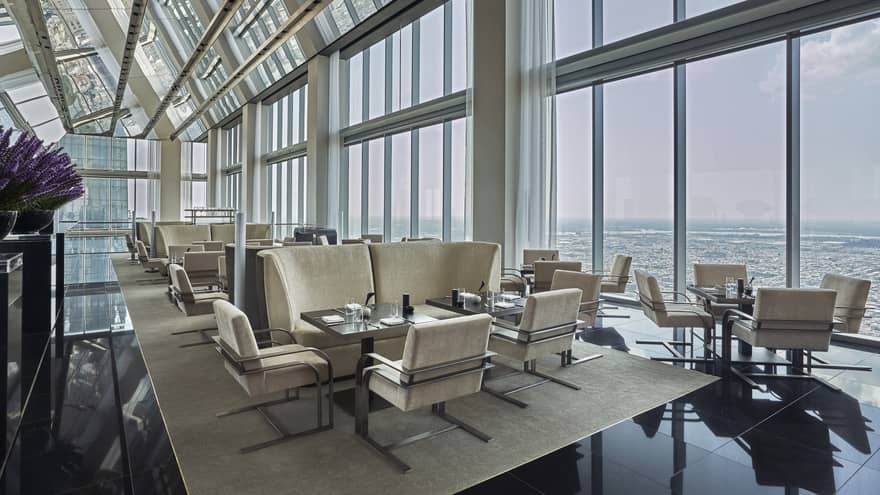 A well lit lounge area in the Skyhigh Lounge overlooking the cityscape. 