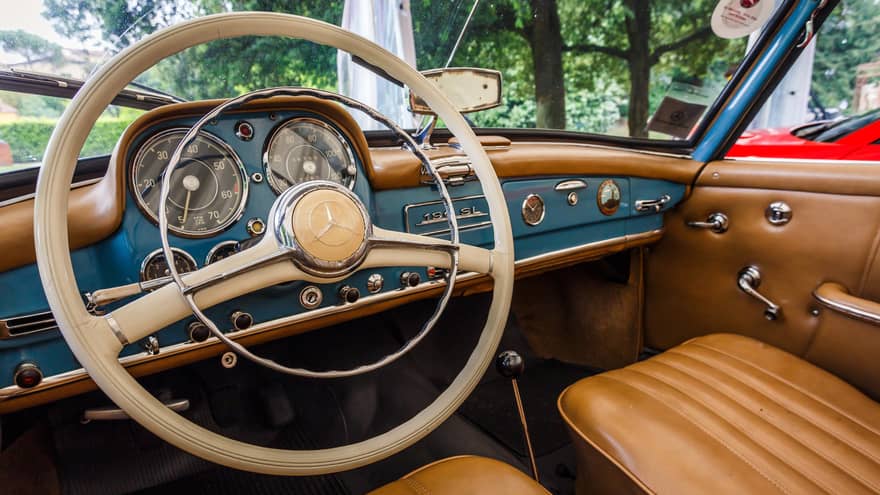 Wheel, dashboard, leather seats of classic luxury car