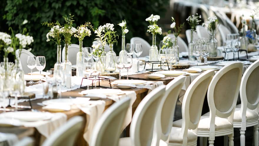 A long table set for a wedding or event outdoors