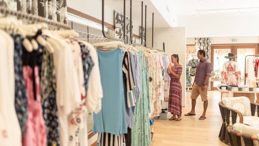 A man and woman shop in a clothing store 