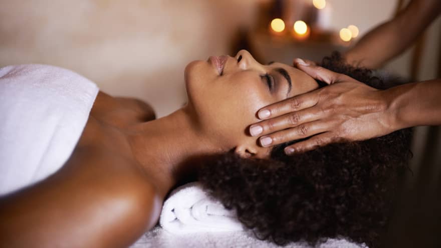 Woman laying down on massage bed getting a massage.