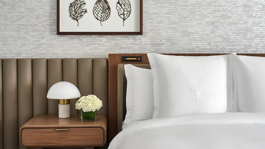 Luxury hotel room with king bed and white Four Seasons?embroidered sheets, at Four Seasons Hotel Washington, DC