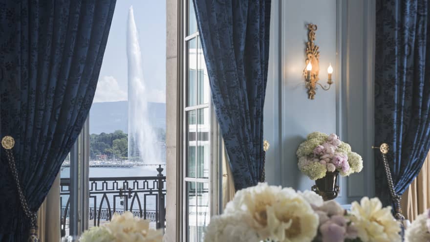 White flowers in Salon Petit Mont Blanc, open door to balcony with fountain view