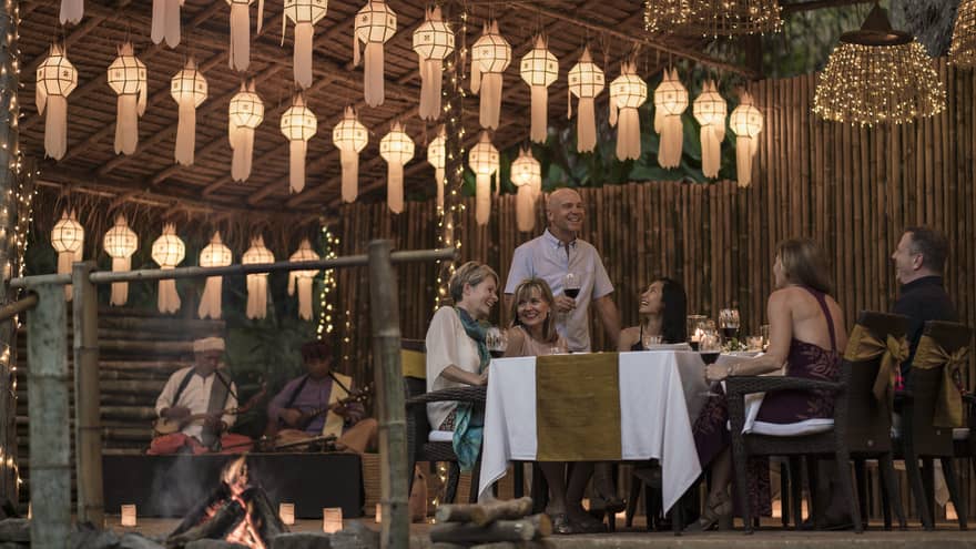 Elephant Camp Dinner, smiling group of diners unders rows of paper lanterns